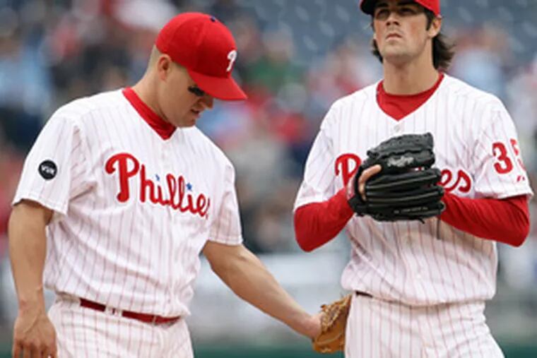 Third baseman Wes Helms (left) consoles Cole Hamels during three-run sixth inning.