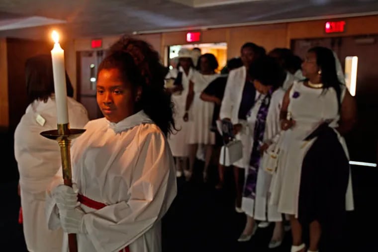 Sohala Bryant waits to lead a procession to the front of the Eisenhower Middle School auditorium to celebrate Ebenezer Methodist Church’s 175th anniversary. (MICHAEL BRYANT / Staff Photographer)