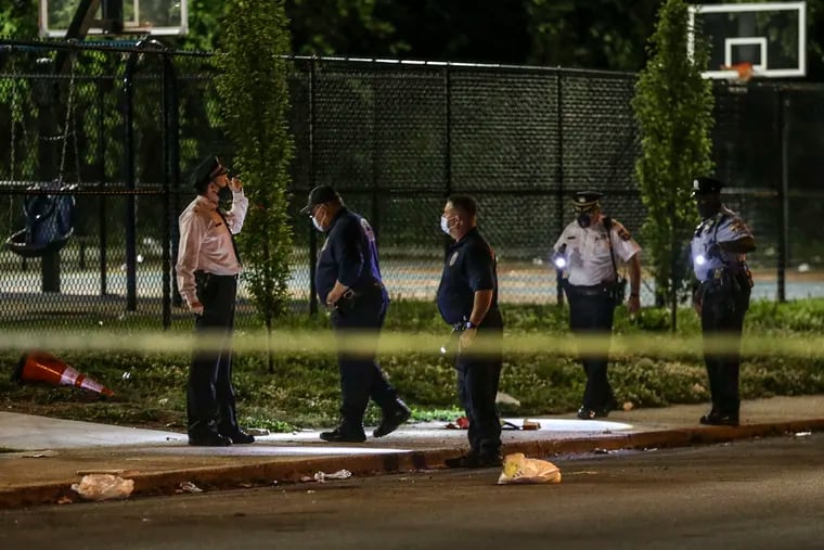 Police look for evidence where a teen was fatally shot and another wounded near the Deritis Playground in the 5600 block of Gray avenue in the 12th police district. Thursday May 13, 2021.