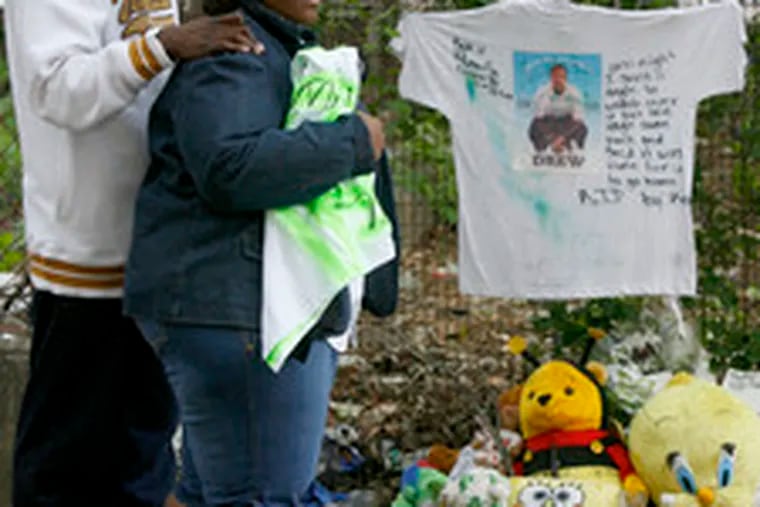 The neighborhood memorial for Andrew Coach is visited by his mother, Sheila Williams and stepfather, Steven Williams. Phila. police believe three men were shot in retribution for his death.