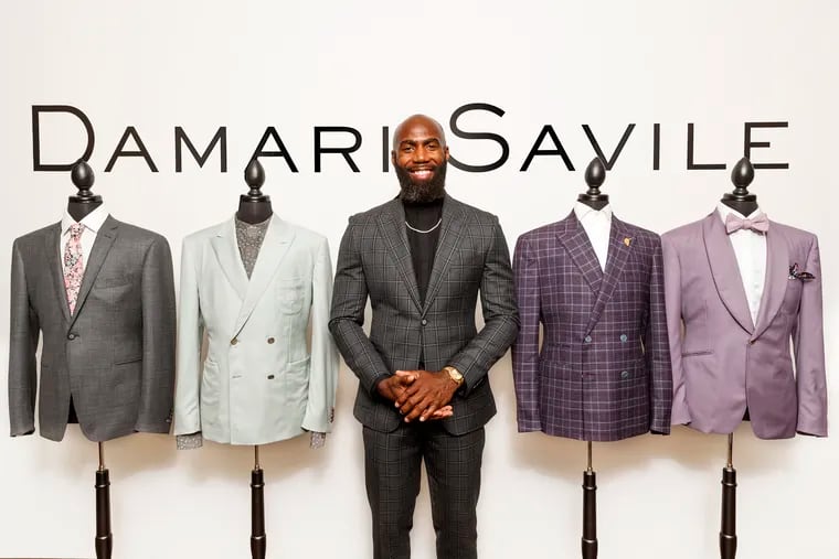Malcolm Jenkins, center, is pictured wearing suits he designed for his Damari Savile collection. These pieces are apart of the spring/summer collection that is available in the store now, or can be purchased on line. (From left to right, the first two blazers are peek lapel, the third is a notch and the last one (purple) is a shawl collar