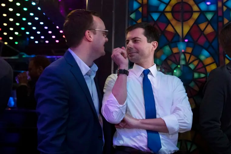 Democratic presidential candidate Pete Buttigieg (right) shares a moment with his husband, Chasten Glezman, while waiting to be introduced at a campaign event in May in West Hollywood, Calif.