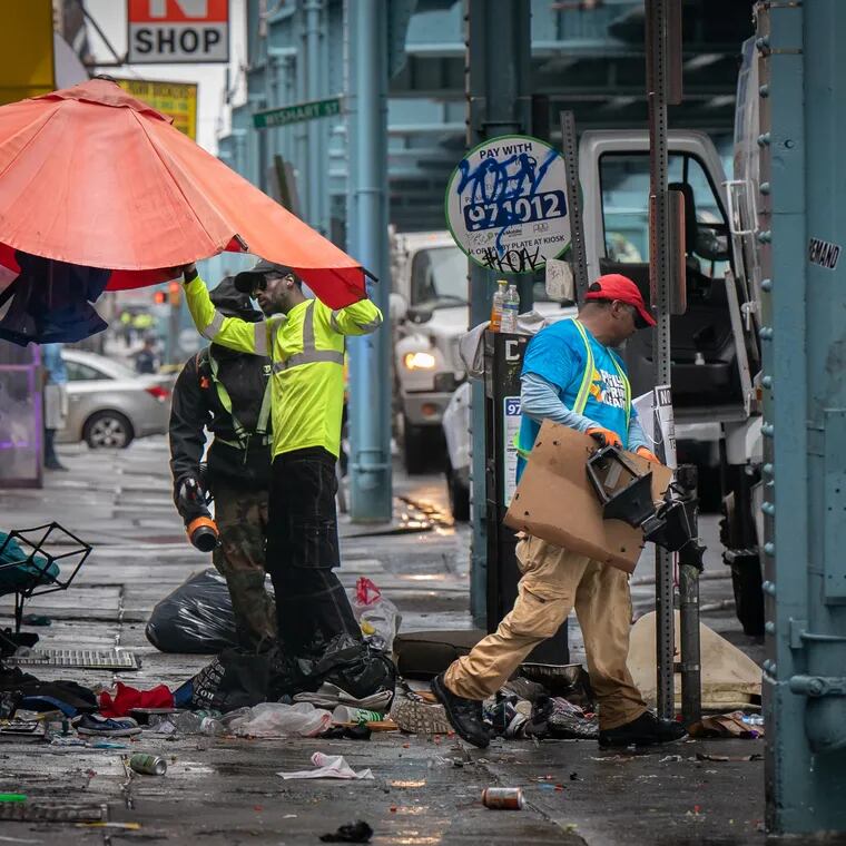 Workers remove debris from the encampment on Kensington Avenue last week. The Parker administration defended the operation over the weekend, saying advocates interrupted the process.