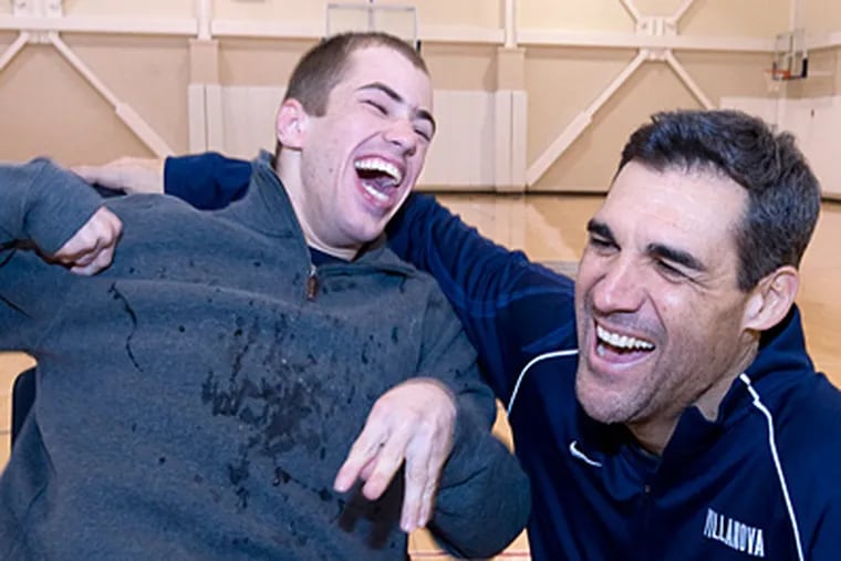 Villanova men’s basketball team manager Frank Kineavy (left) laughs with coach Jay Wright. Kineavy and Nick Gaynor, the women’s squad manager, star in a student documentary. (Clem Murray / Staff Photographer)