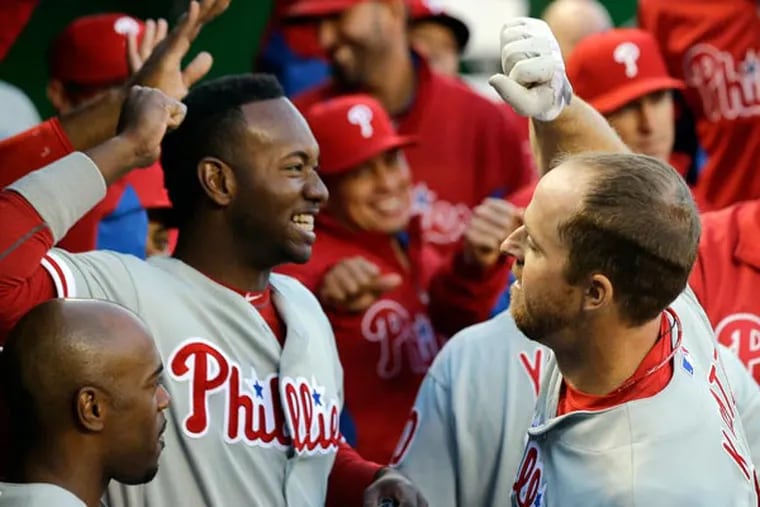 Domonic Brown (left) and Erik Kratz celebrate after their back to back solo home runs during the second inning of a baseball game against the Washington Nationals at Nationals Park, Saturday, May 25, 2013, in Washington. (Alex Brandon/AP)