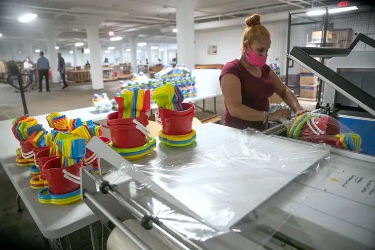 Marilyn Perez, 36, of North Philly, packages children’s toys inside Baker Industries in Kensington. Baker is a non-profit workforce development program that provides work opportunities for people who have been recently incarcerated, have an intellectual or physical disability, who are struggling with housing insecurity or who have a substance use disorder and are in an active recovery program.