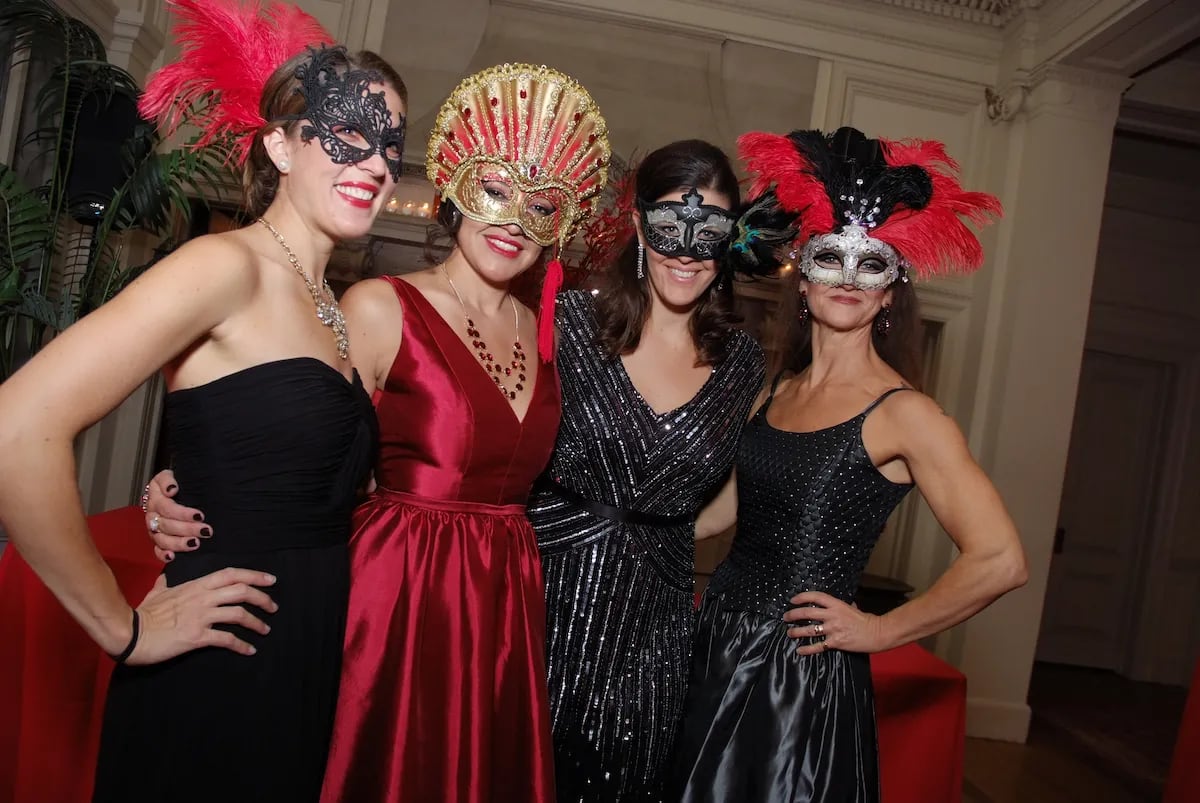 Ball goers pose for a photo at Cairwood Estate's Masquerade Ball in Bryn Athyn, Pa.