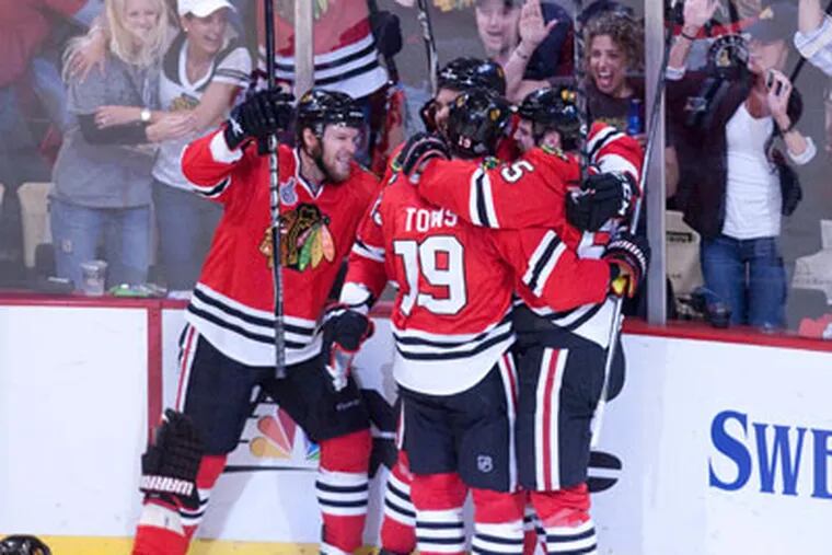 The Blackhawks celebrate after scoring a goal in game two of the Stanley Cup Final.(Ed Hille / Staff Photographer)