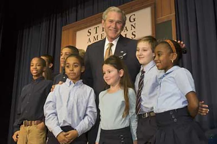 President Bush poses with students during a visit to Kearny Elementary School in Philadelphia today. (Ed Hille / Staff Photographer)