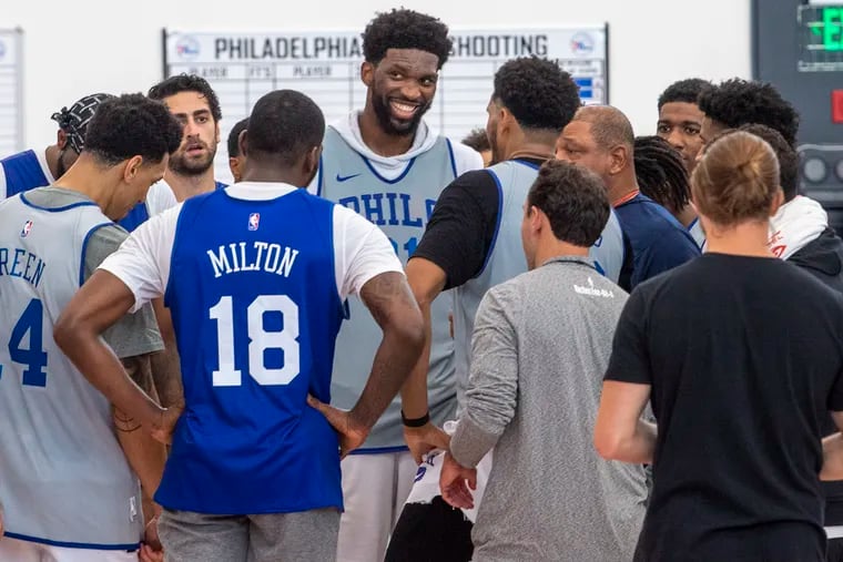 The Sixers gather at the end of the first day of training-camp practice on Tuesday in Camden.