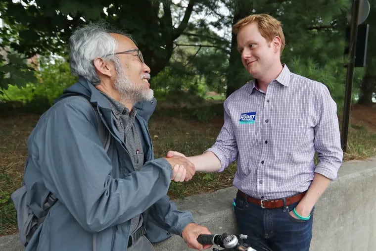 Chris Hurst shakes hands with Jim Tokuhisa, a professor at Virginia Tech, during his campaign for Virginia's House of Delegates.