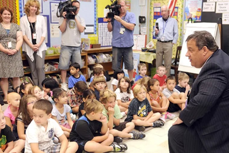 Gov. Christie talking to first graders on Tuesday in the classroom of teachers Sarah Anderson (rear, right) and Kathy Gilmour (rear, left) at Sharp Elementary School in Cherry Hill. (Tom Gralish / Staff Photographer)