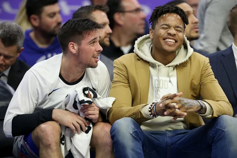 Markelle Fultz and T.J. McConnell talk on the bench during the Sixers' loss to the Cavaliers on Friday.