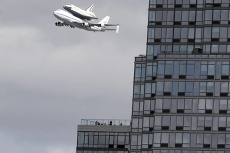 Space shuttle Enterprise, riding on the back of the NASA 747 Shuttle Carrier Aircraft, was flown to its its new assignment in New York City, as an exhibit at the Intrepid Sea, Air, and Space Museum. JOHN MINCHILLO / Associated Press