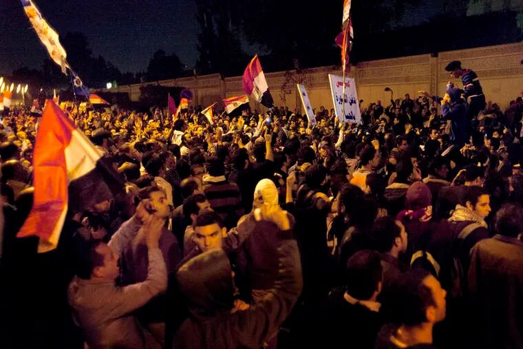 Tens of thousands of protesters chant slogans against the Muslim Brotherhood outside the presidential palace in Cairo.