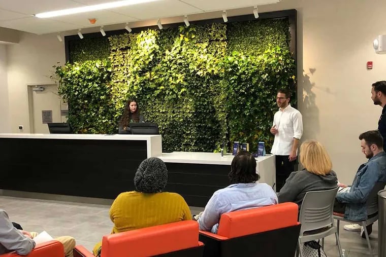 Employees at Restore Integrative Wellness Center, a medical marijuana dispensary on Frankford Ave., listen to a presentation by a cannabis grower.