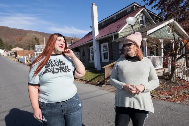 Billie Jean Williams (left) and Stephanie Fritsch walk near their homes in the rural area of Wiconisco, Pa.