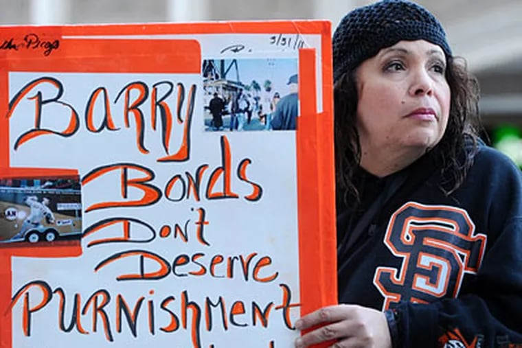 Giants fan Esther Picazo waits for former baseball player Barry Bonds to leave federal court on Friday. (AP Photo/Noah Berger)