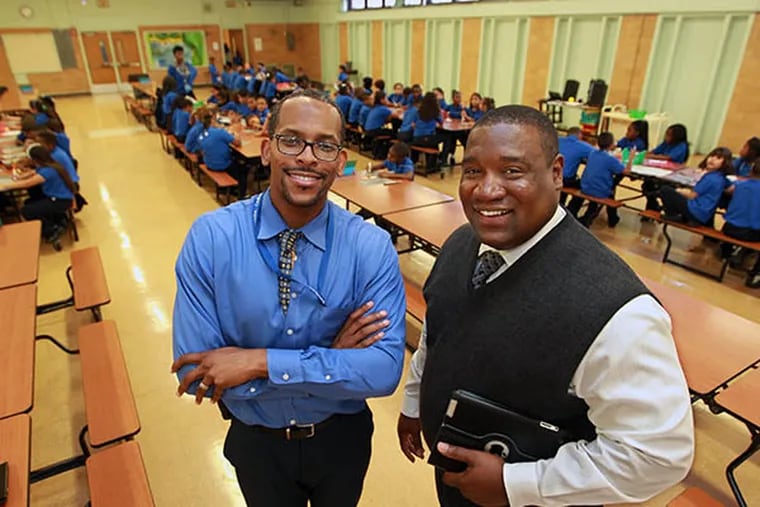 Mastery's North Camden elementary School principal, Brandon Cummings, left, and Pyne Poynt Middle School principle, Tyrone Richards, right, meet in one of the spaces the two school's share, the cafeteria.  ( MICHAEL BRYANT  / Staff Photographer )