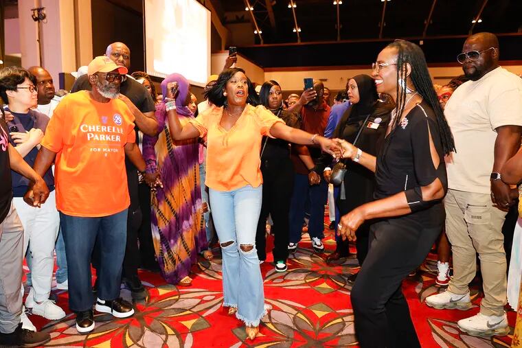 Democratic candidate for Philadelphia mayor Cherelle Parker dances with a supporter during her official victory party at the Pennsylvania Convention Center Friday night, some two weeks after winning the Democratic nomination.