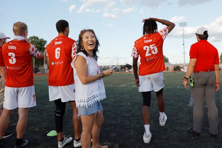 Philadelphia Phoenix president, managing partner and majority owner Christina Lee Chung laughing on the sidelines during a game on July 30.