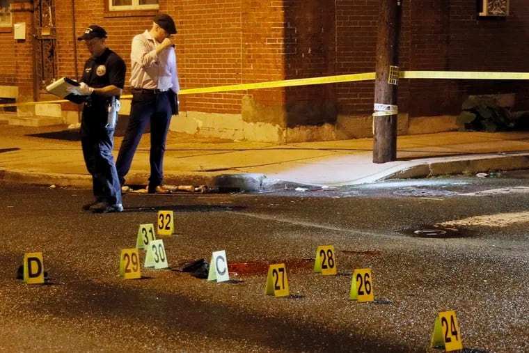 Philadelphia police at S. Cleveland St. and Moore St. in Philadelphia where blood remains on the ground after four people were shot just after 8 pm on Wednesday. Two teenagers died from multiple gunshot wounds.