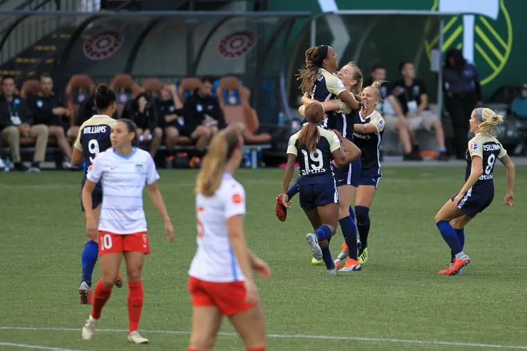 Jessica McDonald jumps into the arms of teammate Samantha Mewis after scoring for the North Carolina Courage against the Chicago Red Stars.