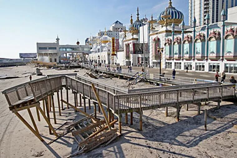 The handicap ramp out to the beach in front of the Taj Mahal Casino in Atlantic City sits in the sand, twisted and broken, after the weekend of heavy weather and surf at the shore. ( Michael Bryant / Staff photographer )