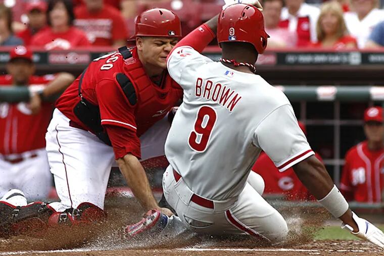 Phillies outfielder Domonic Brown is tagged out at home by Reds catcher Devin Mesoraco during the fourth inning on Sunday, June 8, 2014, in Cincinnati. (David Kohl/AP)