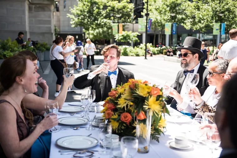 Actors sipped from empty wine glasses during the Covenant House's "Invisible Lunch" on Friday, June 15 at Dilworth Park.