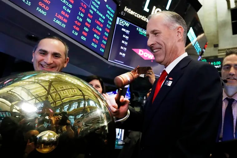 Dow CFO & President Howard Ungerleider, left, looks on as CEO Jim Fitterling rings a ceremonial bell marking the start of Dow trading, as it separates from DowDuPont. on the floor of the New York Stock Exchange, on April 2, 2019. Two more split-offs are occurring this week.