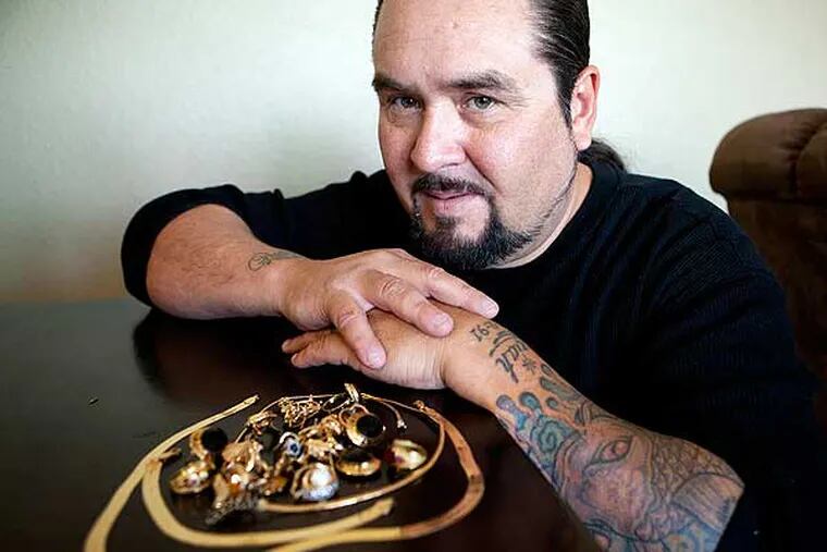 Lou Rosas poses with his late mother's gold jewelry in his apartment in San Jose, California, on Friday, April 19, 2013. Rosas wants to sell it, but not while the price of gold is low. (LiPo Ching/San Jose Mercury News/MCT)