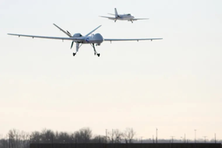 The Predator B drone (left), the first unmanned aircraft system to patrol the northern U.S. border, goes in for a landing after yesterday&#0039;s six-hour flight.