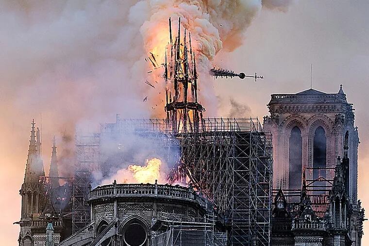 Flames and smoke rise as the spire on Notre Dame Cathedral, added to the structure in the 19th century, collapses in Paris on Monday.