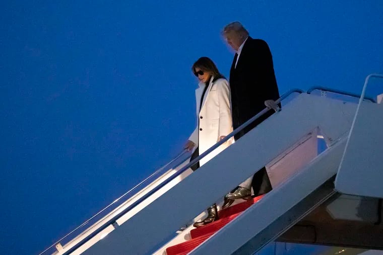 President Donald Trump, and first lady Melania Trump, step off Air Force One upon arrival, Wednesday, Feb. 26, 2020, at Andrews Air Force Base, Md. Trump is returning from India.