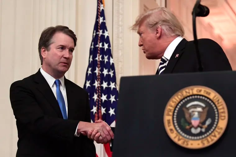 President Donald Trump, right, shakes hands with Supreme Court Justice Brett Kavanaugh, left, before a ceremonial swearing in in the East Room of the White House in Washington, Monday, Oct. 8, 2018.