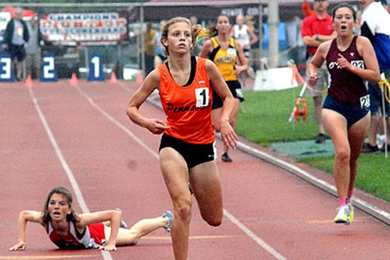 In the 3200 meter race, Sara Sargent of Pennsbury wins and sets a record, as competitor Katie Kinkead of Central Bucks falls down. (April Saul / Staff Photographer)