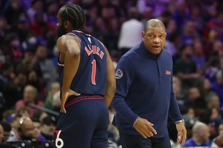 Sixers head coach Doc Rivers speaks with point guard James Harden during Tuesday's loss to the Milwaukee Bucks.