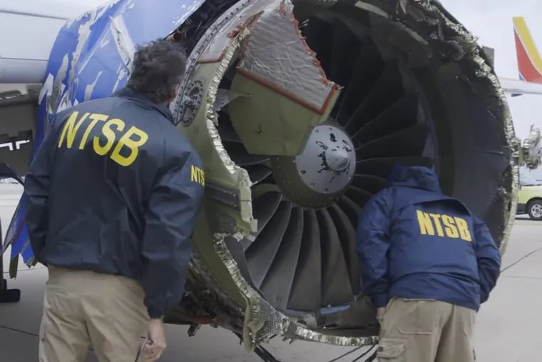 A National Transportation Safety Board investigator examines damage to the engine of the Southwest Airlines plane that made an emergency landing in Philadelphia.