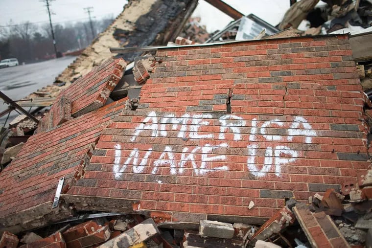 Graffiti on a business destroyed in Dellwood, Mo., during November rioting, which broke out after residents learned the police officer who shot and killed Michael Brown, 18, would not be charged.