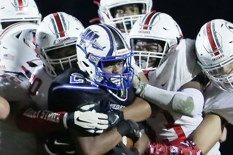 Lenape's defense, shown here in a gang tackle of Williamstown’s Lorenzo Hines, has led the way as the Indians have risen to the No. 1 spot in the South Jersey Top 10.