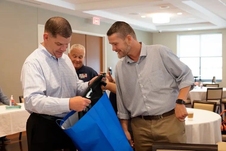 Brian Eddis, right, of the Philadelphia Building Trades Council, presents a gift bag of Philadelphia sports apparel to US Secretary of Labor Marty J. Walsh at the Laborers’ Training and Learning Center on July 3, 2021. Eddis was removed from his job as a business agent with the Council last week.