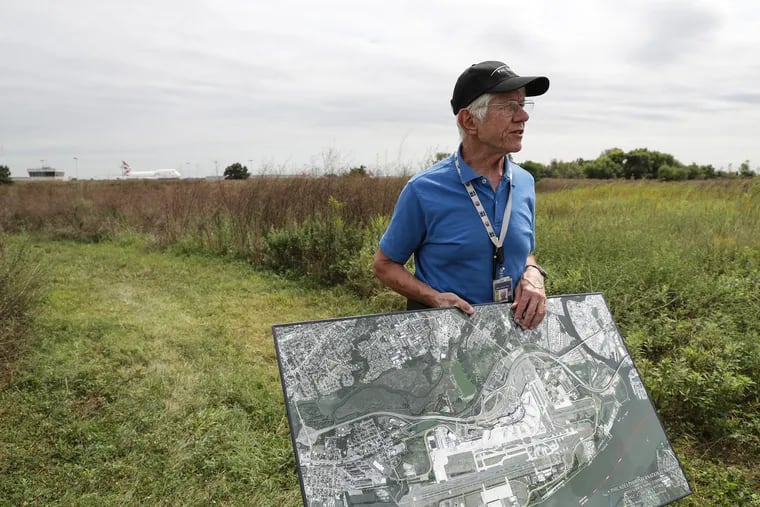 Ray Scheinfeld, who is the Airport Environmental Manager at Philadelphia International Airport, displays a satellite image of the airport on a parcel of recently acquired land in Philadelphia, PA on September 5, 2019.