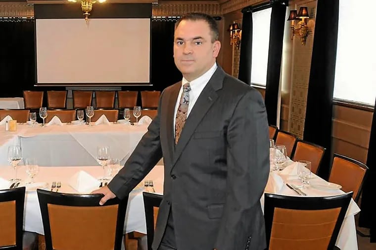 In this 2013 photo,  Montgomery County financial adviser Dean Vagnozzi stands in a room at Ruth Chris Steakhouse in King of Prussia, where he has pitched potential investors about putting their money into life settlements.