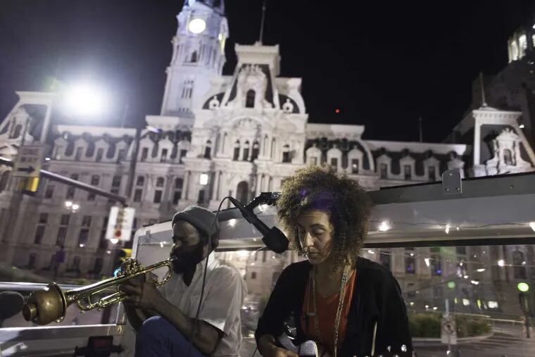 Vessna Scheff, who sings and plays ukelele, with   Koofreh Umoren, playing trumpet, perform in the Double Decker Music Series as the bus passes Philadelphia City Hall on Aug. 28, 2016. (Photo: Scott Troyan)