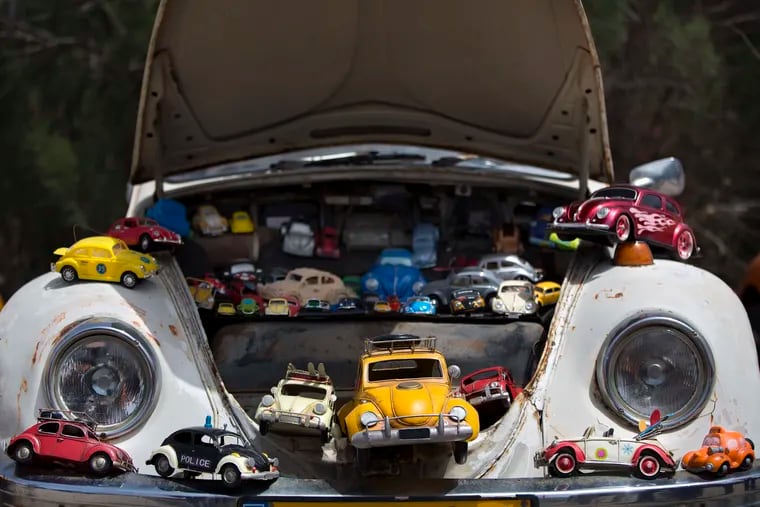FILE - In this April 21, 2017, file photo a collection of VW beetles car toys seen on Volkswagen Beetle displayed during the annual gathering of the "Beetle Club" in Yakum, central Israel. Volkswagen is halting production of the last version of its Beetle model in July 2019 at its plant in Puebla, Mexico, the end of the road for a vehicle that has symbolized many things over a history spanning eight decades since 1938.