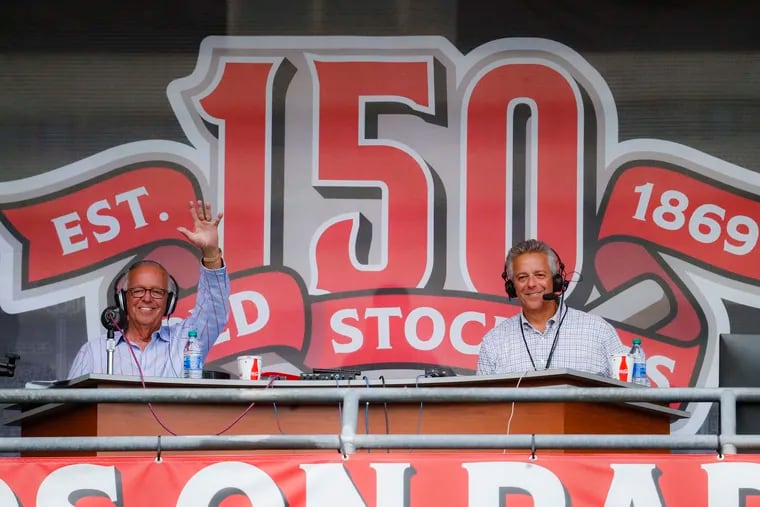Thom Brennaman (right) sits with his father, Cincinnati Reds radio announcer Marty Brennaman, at a Reds game in 2019.