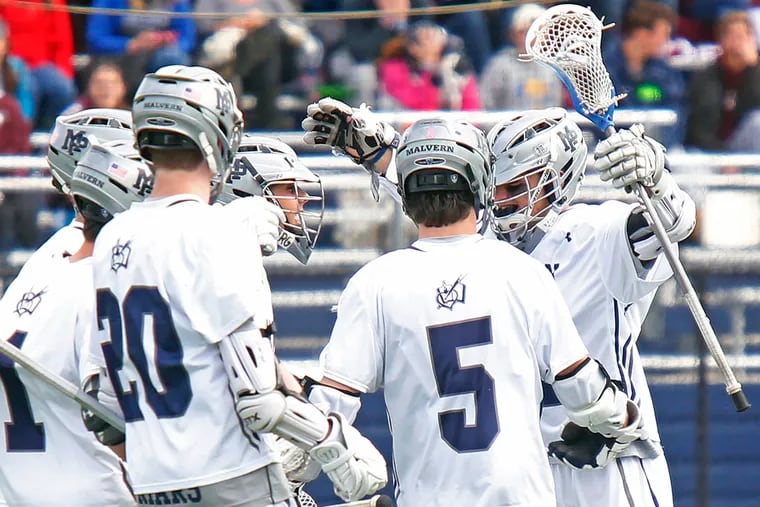 Malvern Prep's Billy Coyle (right) celebrates his game-winning goal against Garnet Valley with teammates, including A.J. Traynor (1), Quinn McCahon (20) and Mike Fay (5). Coyle's score with 2.9 seconds remaining gave the Friars an 11-10 victory in a nonleague lacrosse game.