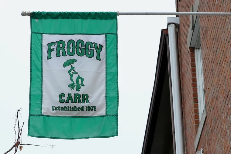 A Froggy Carr flag hangs from a building next to the group's clubhouse in South Philadelphia on Friday, Jan. 3, 2020. The group is under fire after several men were spotted wearing blackface while marching with them during the Mummers Parade on Wednesday.
