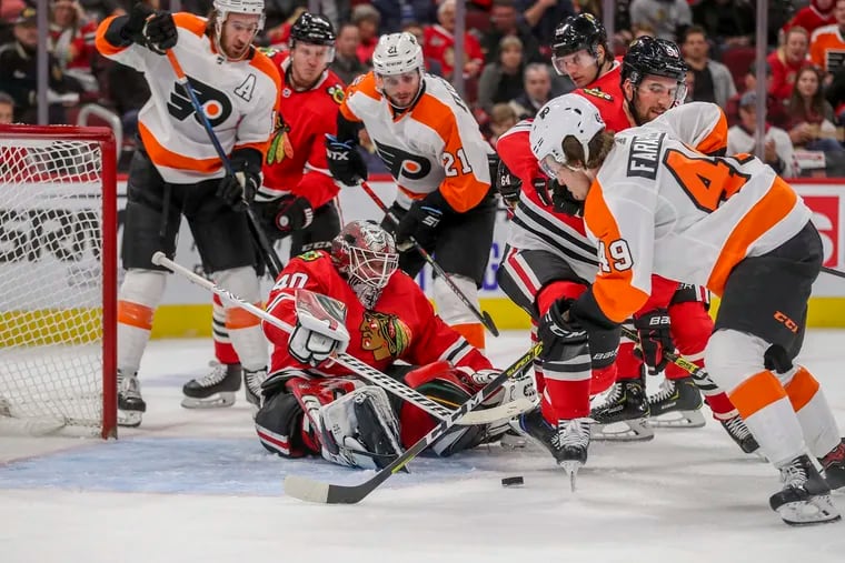 Chicago Blackhawks goaltender Robin Lehner guards the net while the Flyers' Joel Farabee (49) looks to score Thursday amid second-period traffic at the United Center.